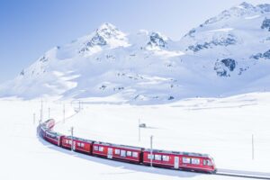 Bernina Express: A scenic train journey through the breathtaking landscapes of the Swiss Alps, offering panoramic views of snow-capped peaks, charming villages, and alpine meadows