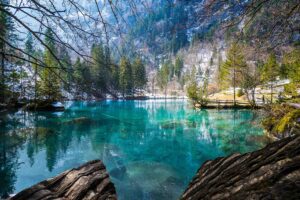 Enchanting Blausee in Switzerland - Discover the Crystal-Clear Waters and Lush Surroundings of this Alpine Lake