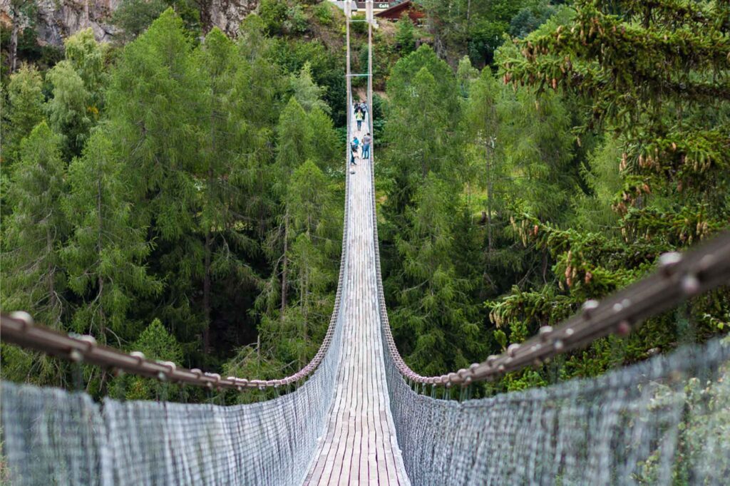 Quaint wooden bridge nestled in the picturesque town of Zermatt, surrounded by the Swiss Alps