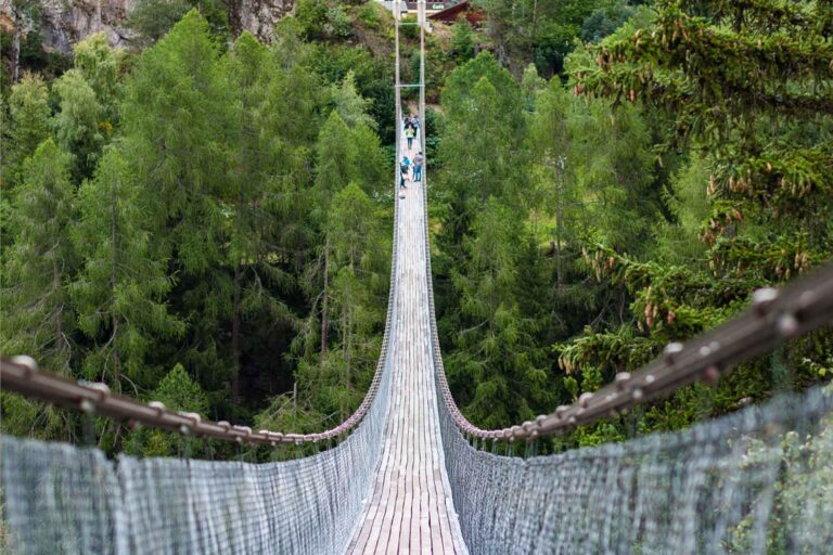 Quaint wooden bridge nestled in the picturesque town of Zermatt, surrounded by the Swiss Alps