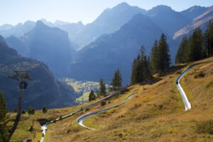 Grindelwald Pfingsten Rodelbahn: A thrilling ride down the alpine toboggan run, surrounded by the stunning landscapes of Grindelwald, Switzerland.