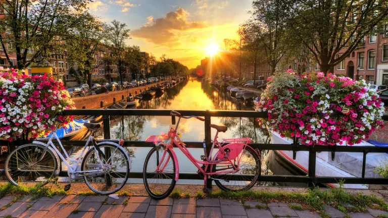Amsterdam: A vibrant cityscape with picturesque canals, historic architecture, and a lively atmosphere, capturing the essence of Dutch culture and urban charm