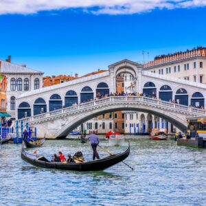 Rialto Bridge: An iconic landmark in Venice, Italy, spanning the Grand Canal and showcasing the beauty of Venetian architecture and bustling city life