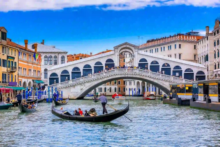 Rialto Bridge: An iconic landmark in Venice, Italy, spanning the Grand Canal and showcasing the beauty of Venetian architecture and bustling city life